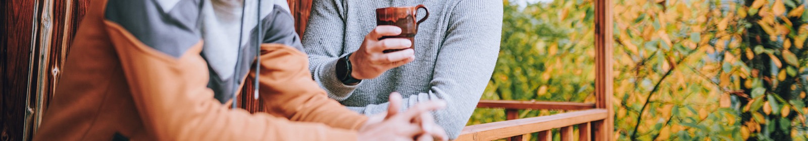 two people on deck drinking coffee