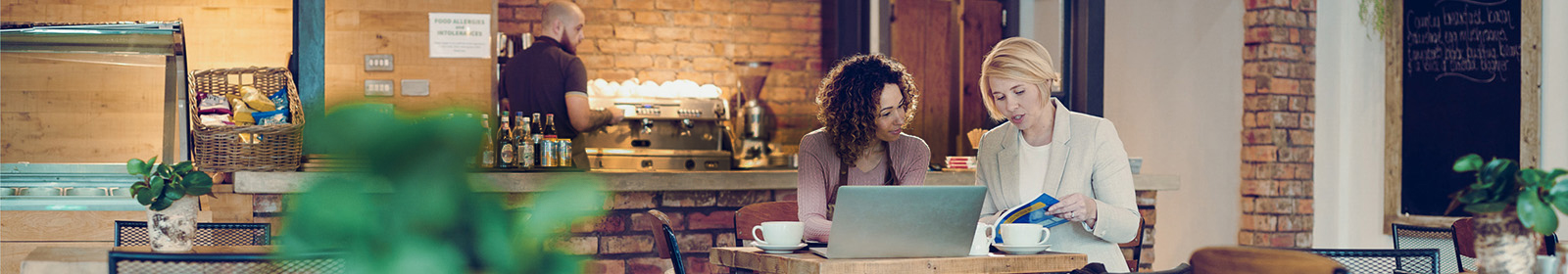 Two people at a computer in a business