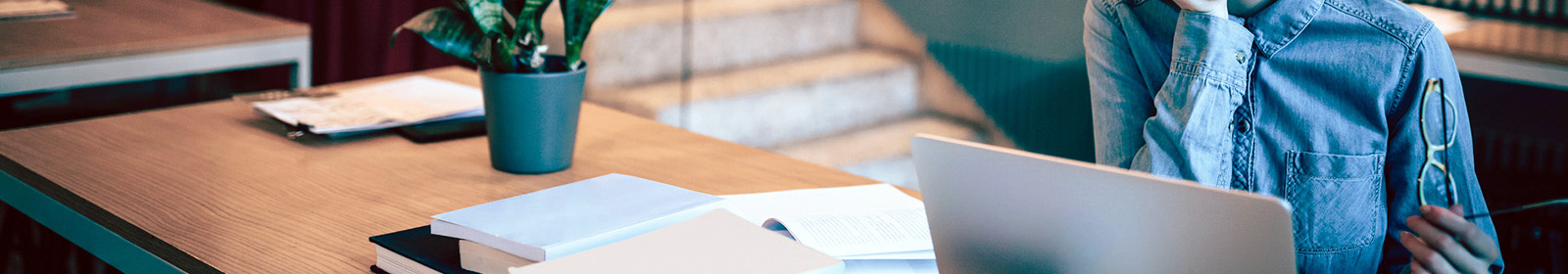 person sitting at desk with open laptop