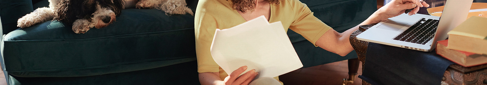 Person on computer holding paper