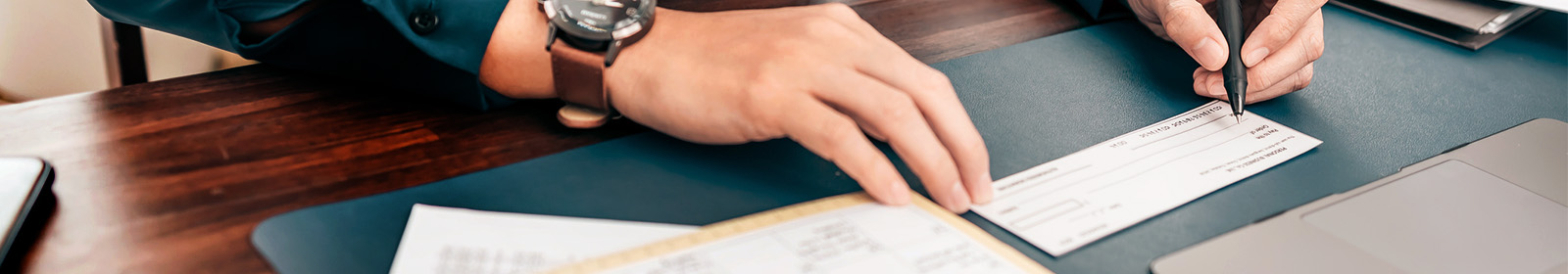 zoomed in image of person writing a check