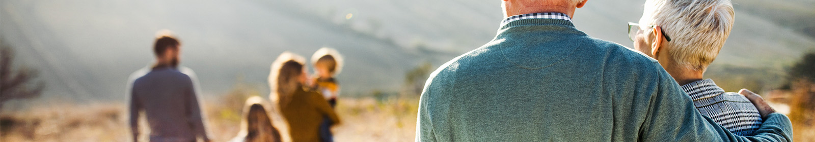 older couple looking fondly at young family