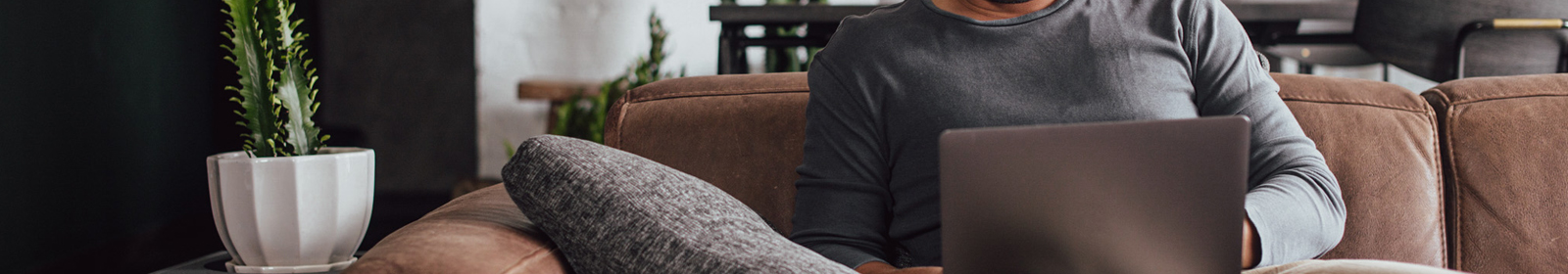 person sitting on couch with laptop open