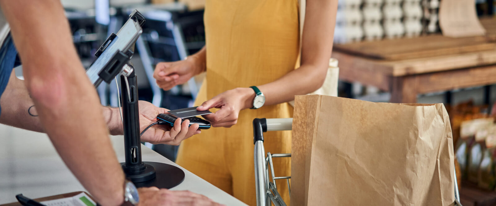 Person paying for groceries with a credit card