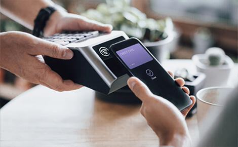 Person paying with digital card on a smartphone